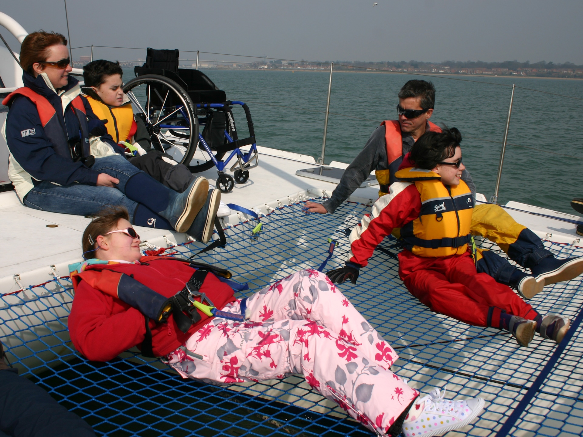 A group from the Whizz Kids charity relax after sailing to Cowes.